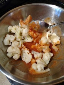 mixing cauliflower in bowl